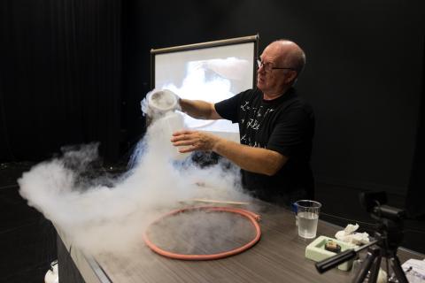 Photograph of CERN scientist experimenting with liquid nitrogen.